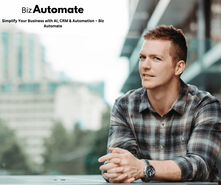 man in checkered shirt sitting with hands on a table wearing a watch 