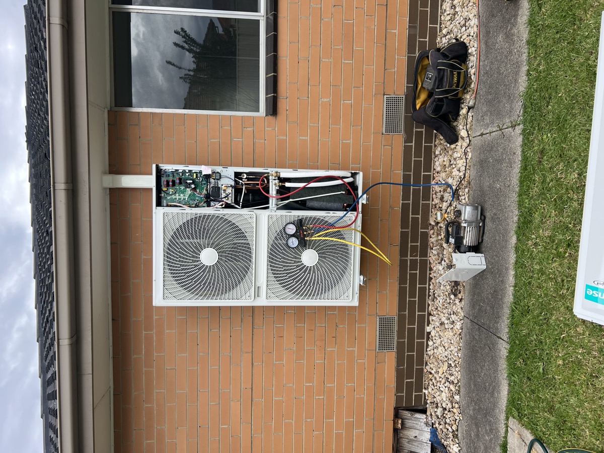 HVAC technician servicing a ducted system