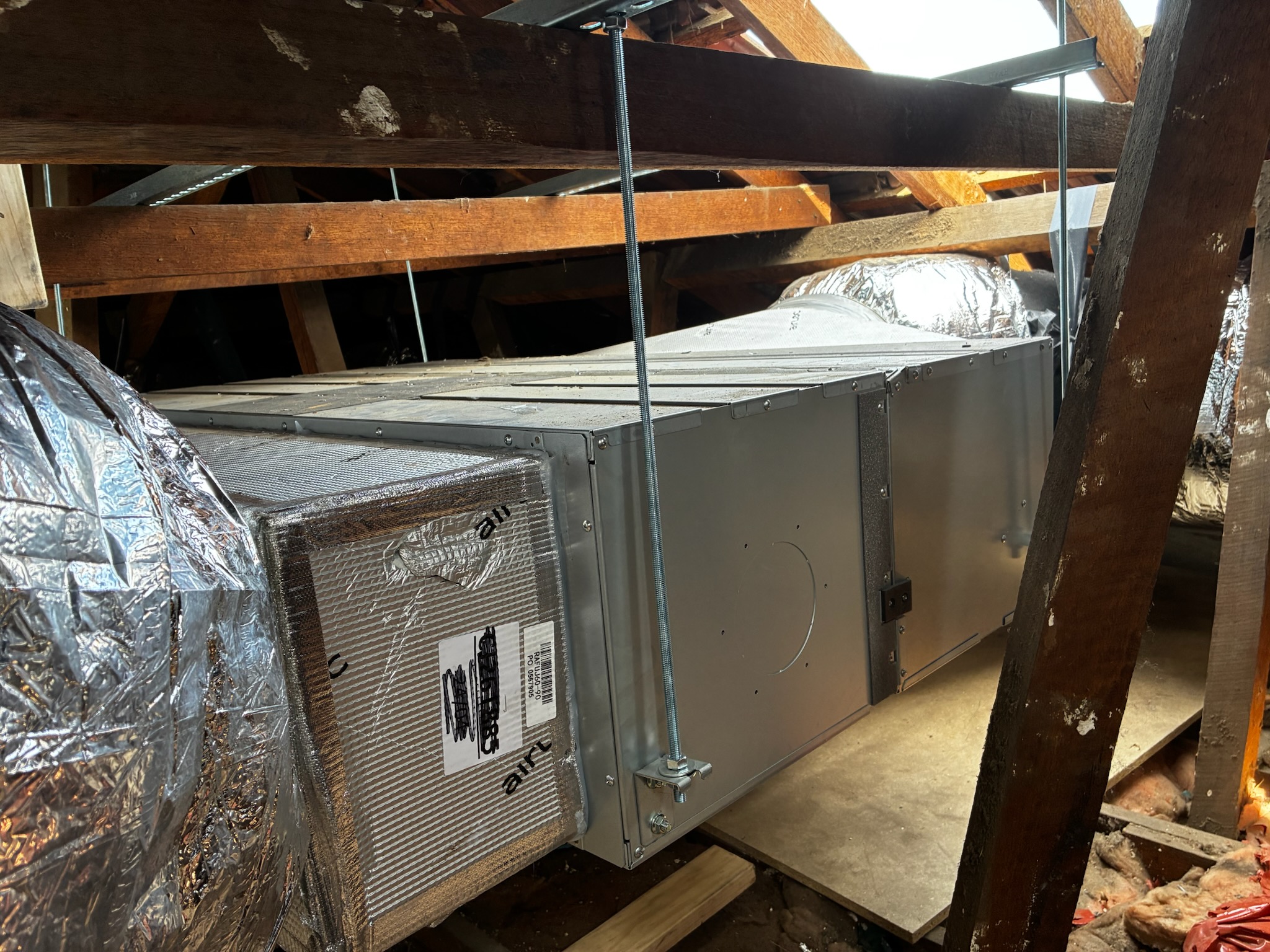 Ducted air conditioning unit installed in roof cavity