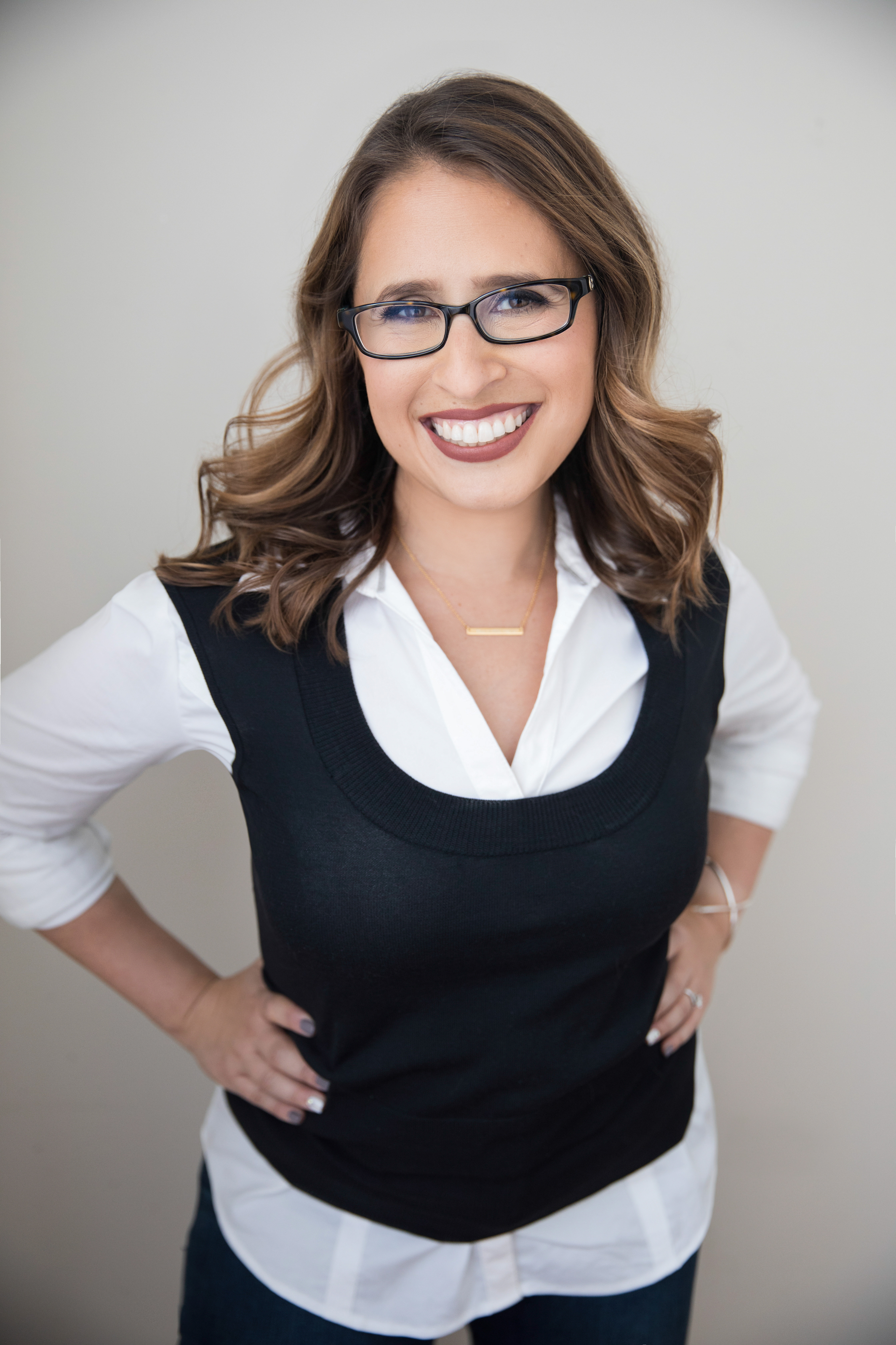 Ilana, motherhood coach and grief support specialist, smiling beside the contact form