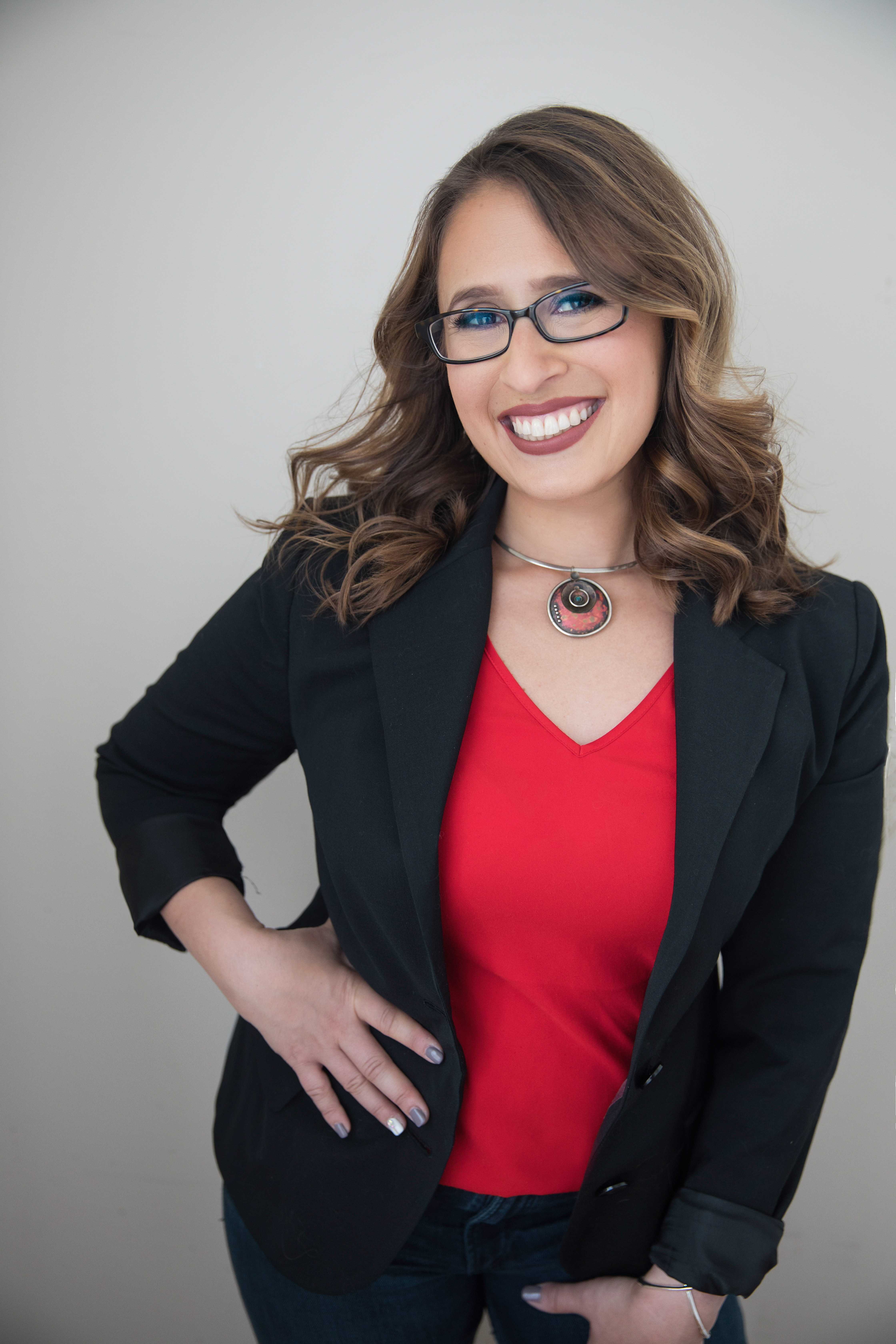 Ilana, motherhood coach and grief support specialist, smiling in a professional headshot