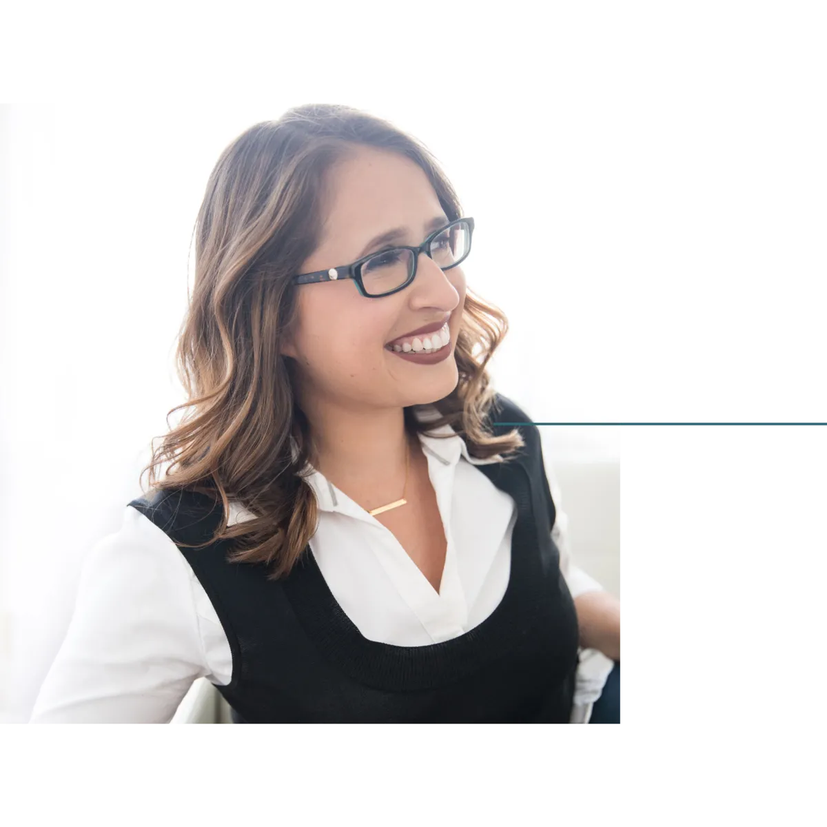 Ilana, motherhood coach and grief support specialist, smiling and looking off camera