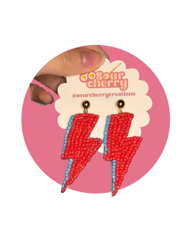 Red and blue beaded lightning bolt earrings on a Sour Cherry card