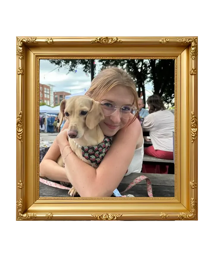 Jaymie holding her dachshund at a Charleston market