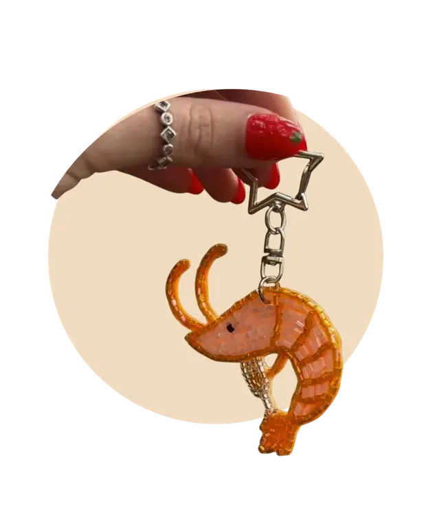 Beaded shrimp keychain held up on a keyring