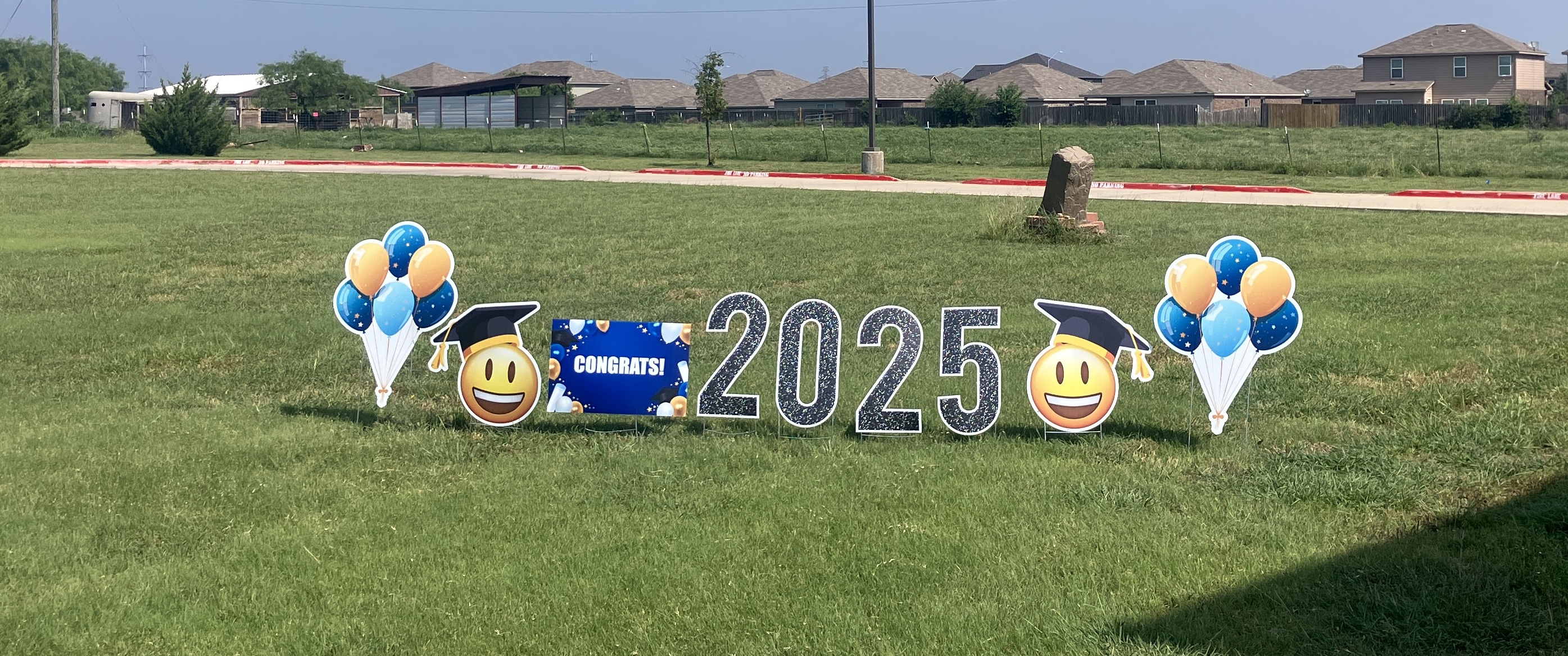 Real graduation congrats yard display for the Class of 2025 with balloons