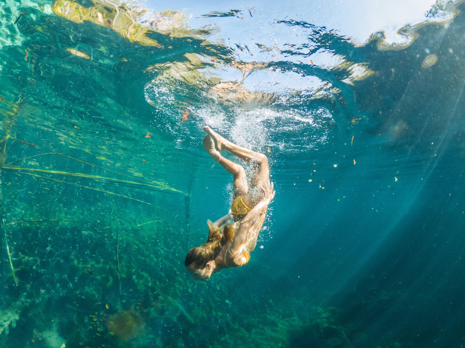 Person diving into turquoise water