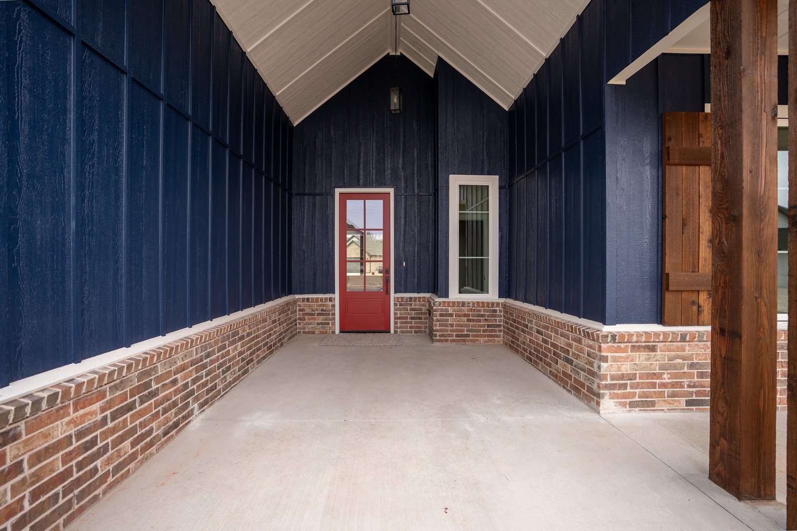 Entry with a red front door and navy board-and-batten walls