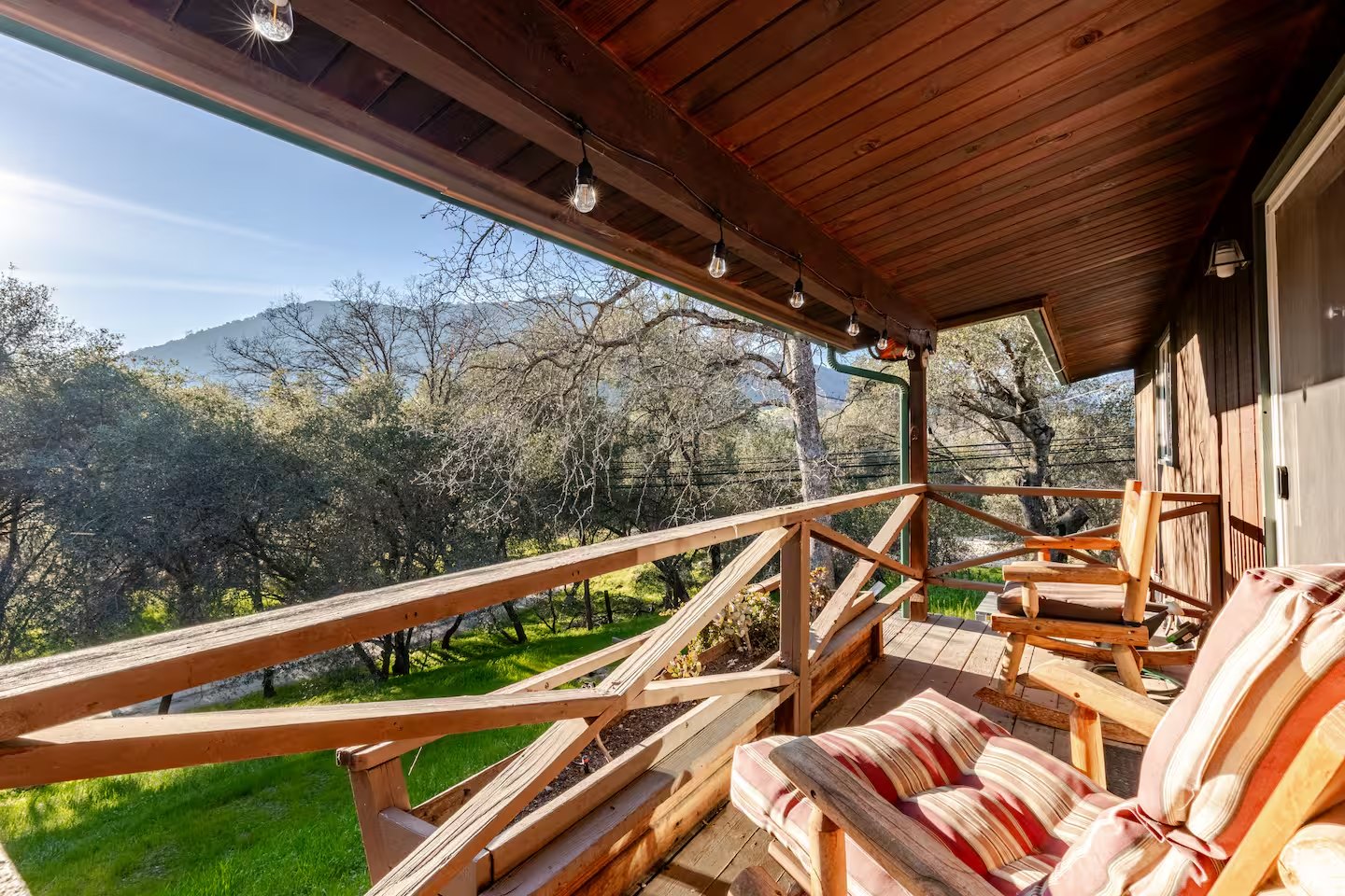 Covered wood deck with a mountain view in the foothills