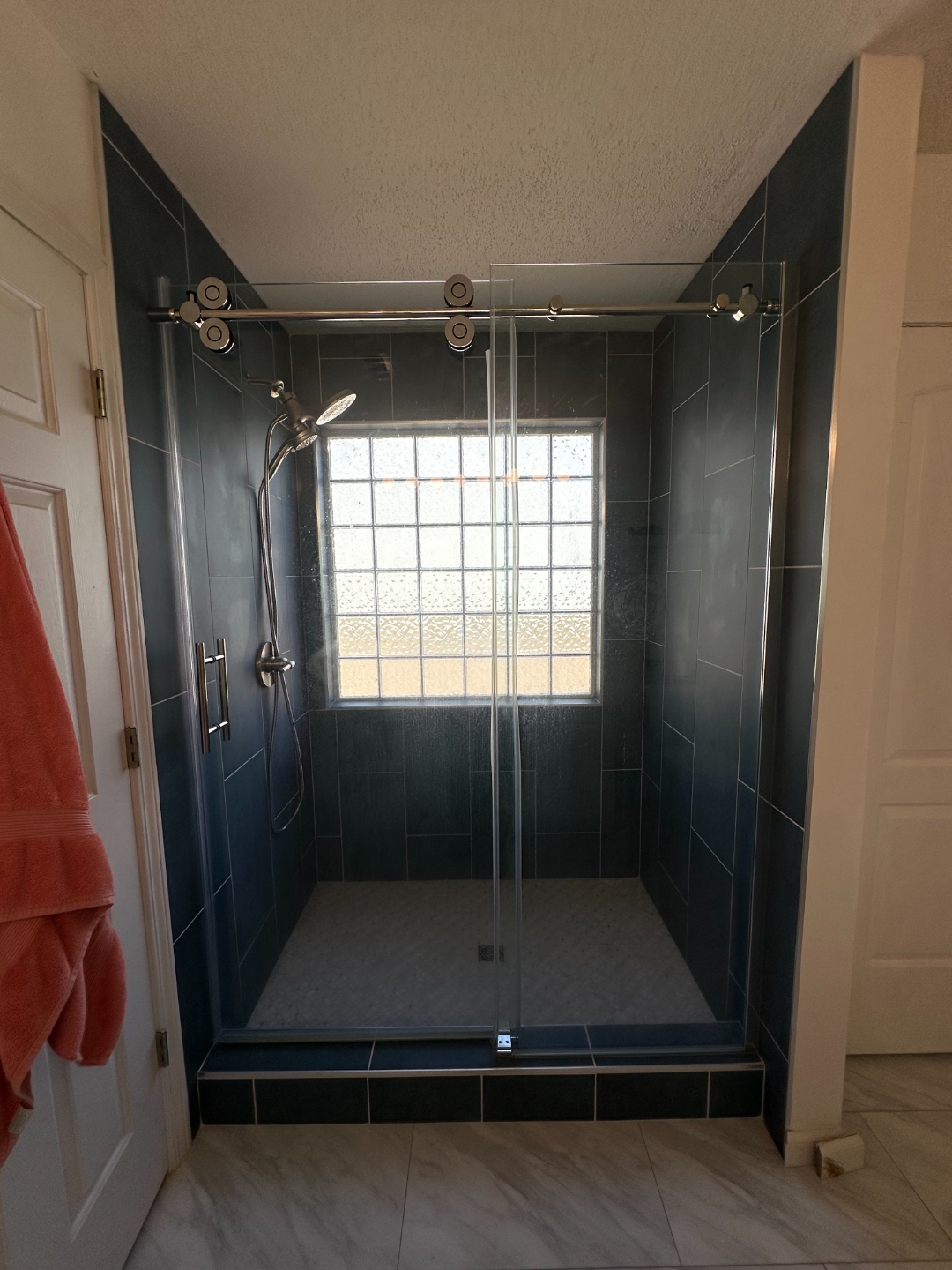 Custom angled glass enclosure in a modern bathroom