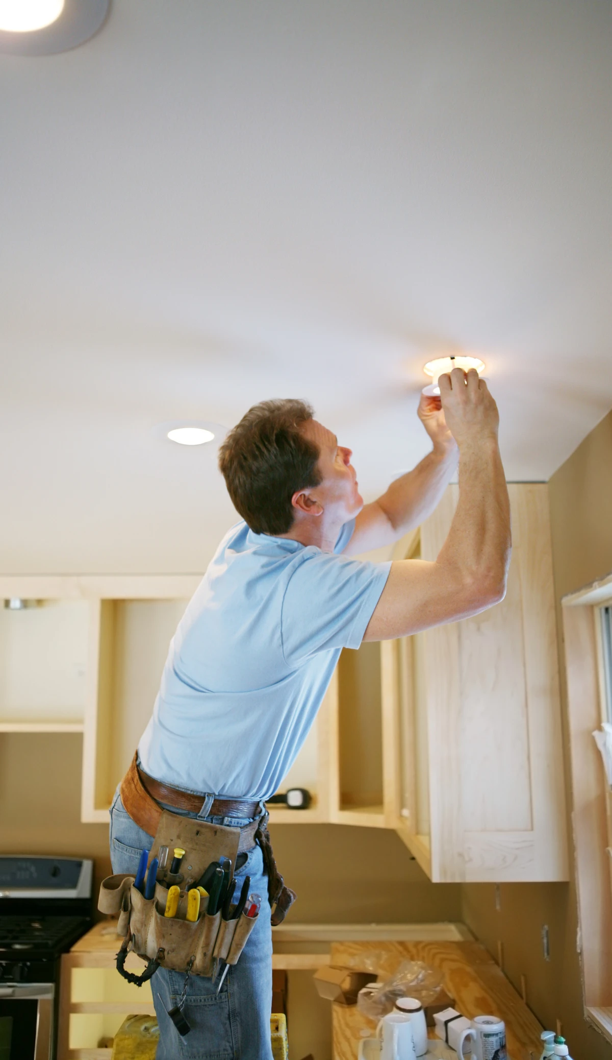 Handyman installing recessed ceiling light fixture — New Generation Handyman, Alpharetta GA