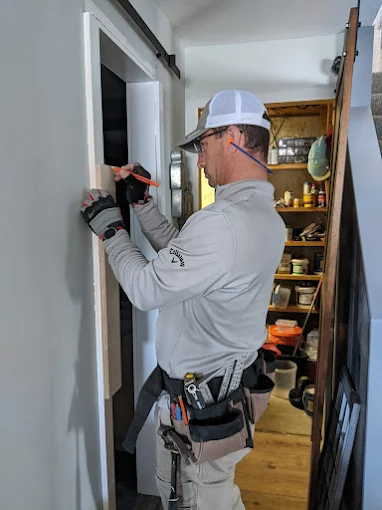 Handyman installing interior door during home repair service — New Generation Handyman, Alpharetta GA
