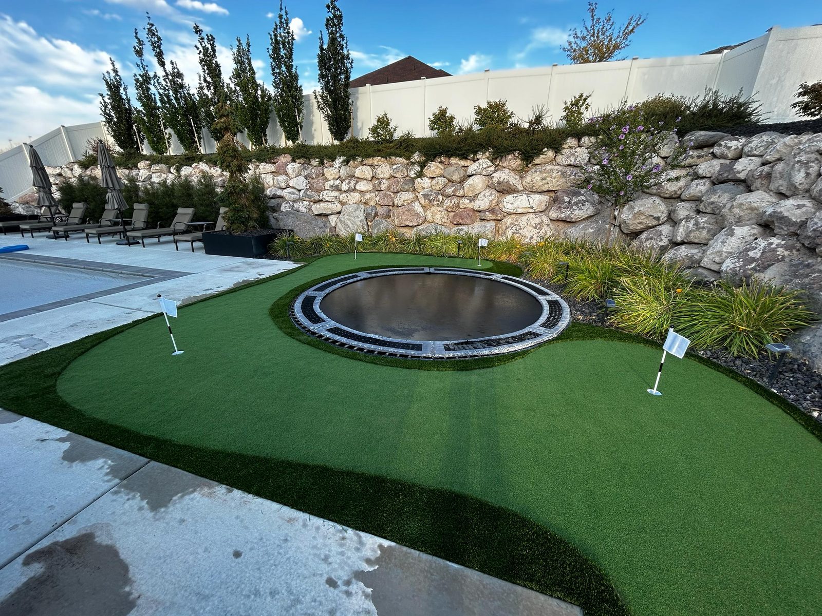 Artificial turf installation in Utah. Putting green with fringe & flags