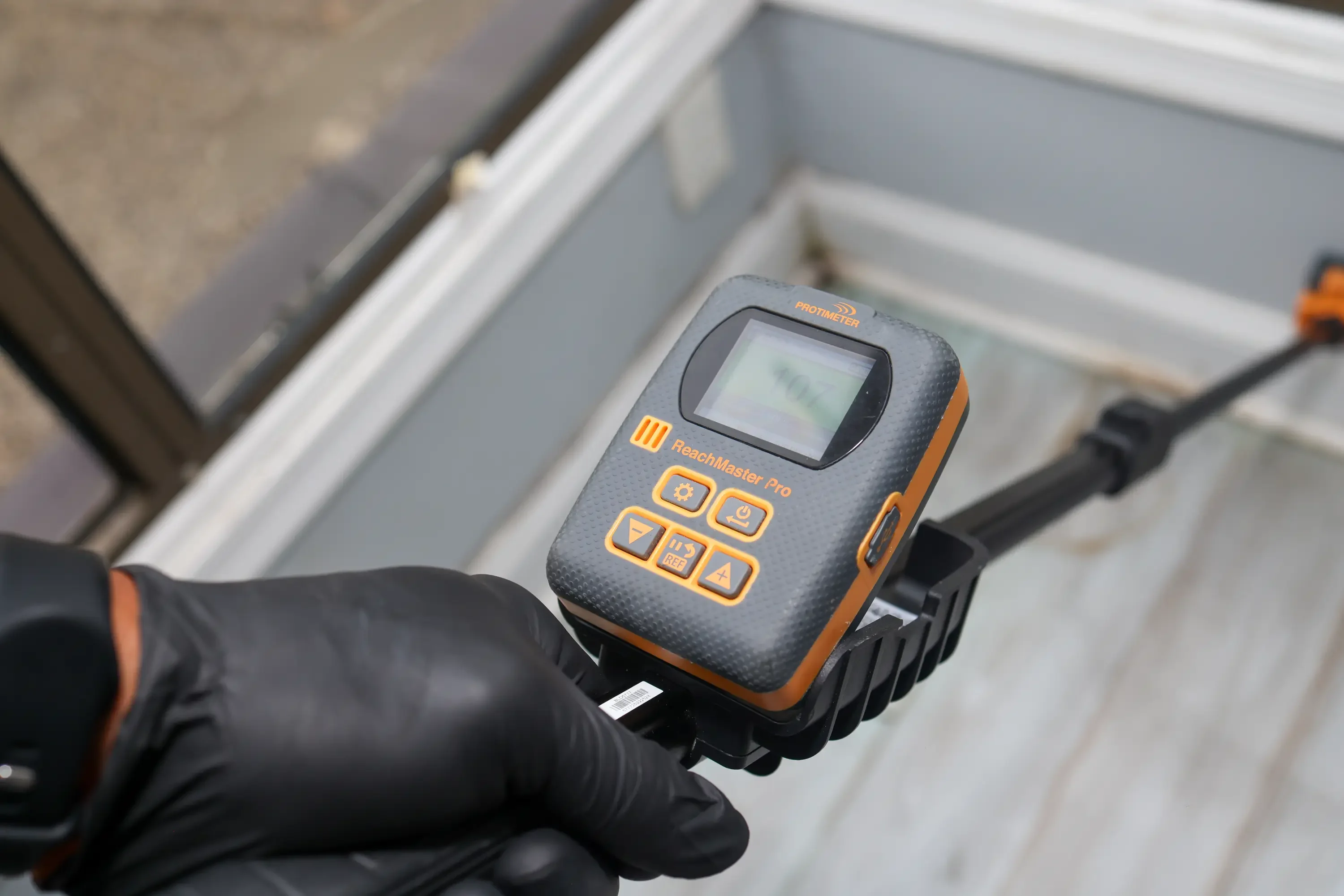 Technician performing moisture testing during environmental assessment