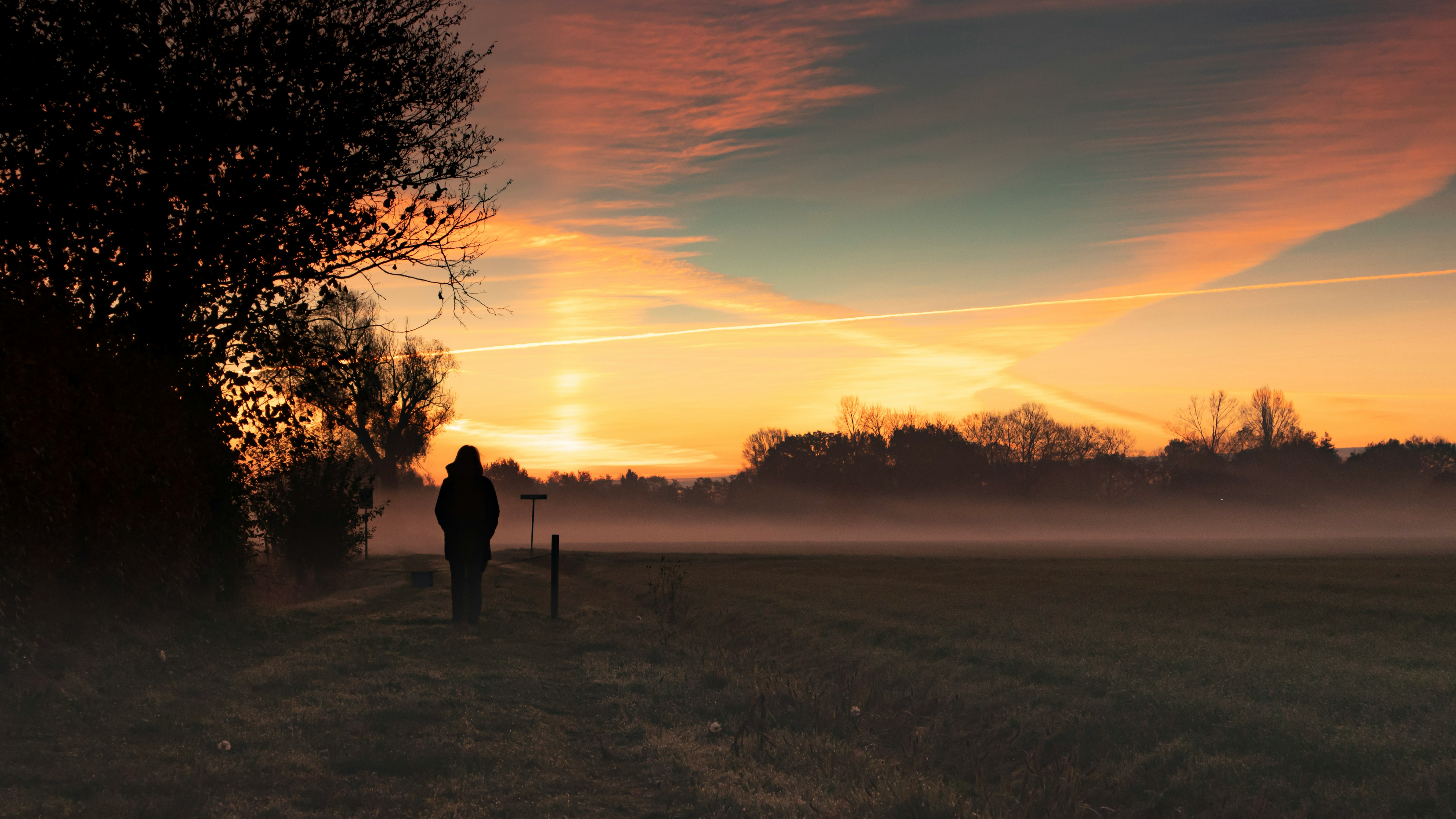Person walking towards sunlight