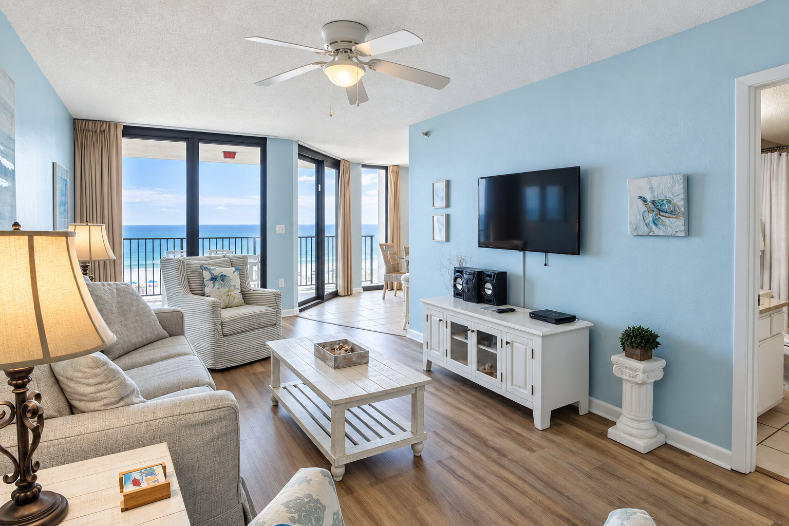 Living room of a Phoenix East II condo in Orange Beach, Alabama, with floor-to-ceiling windows looking out over the Gulf