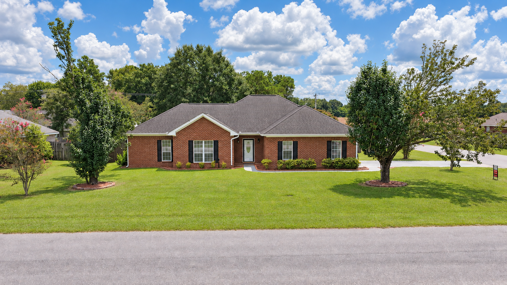 Front exterior of a four-bedroom home in Robertsdale, Alabama photographed in daylight