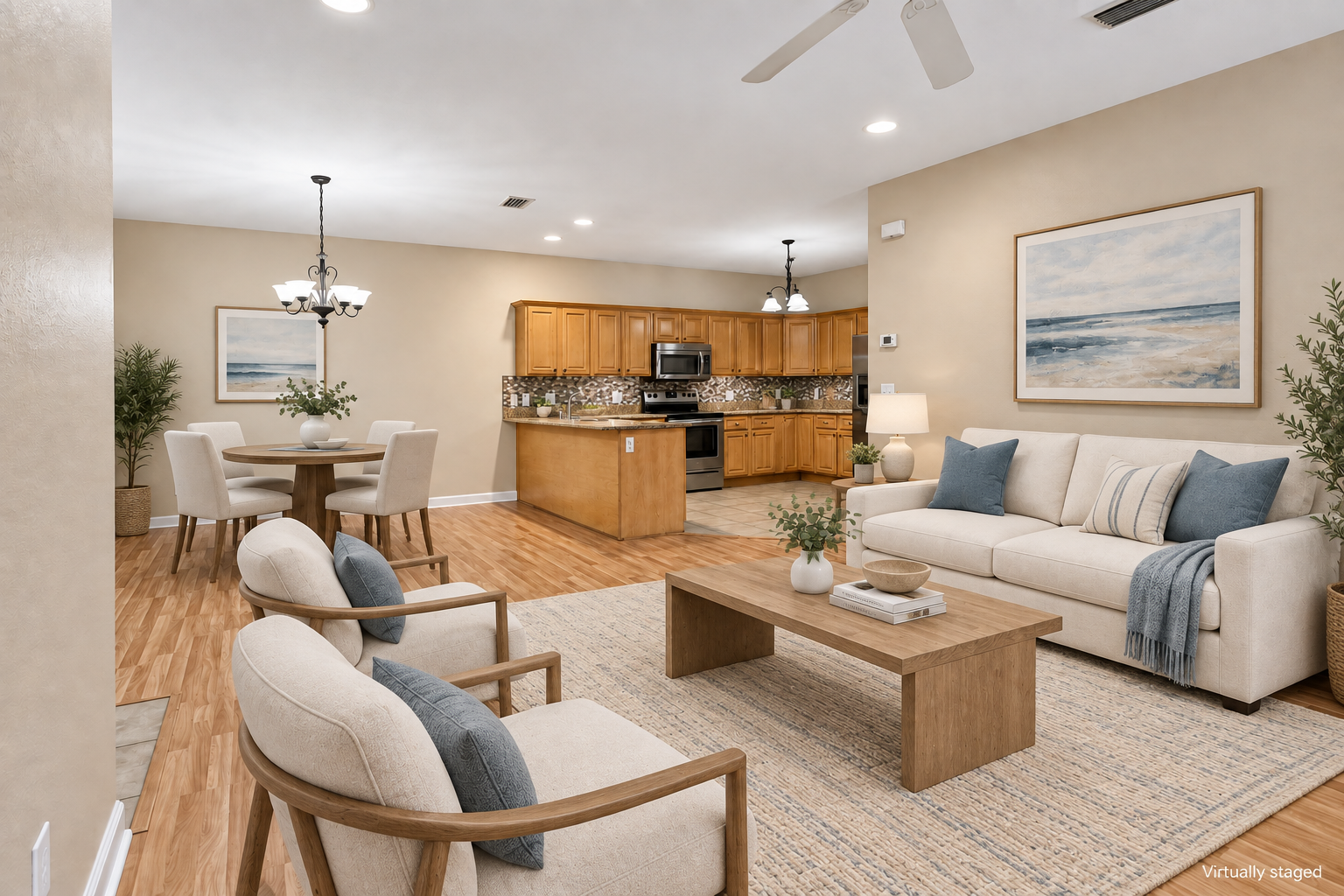 The same Robertsdale living room shown with virtual staging: a sofa, area rug, accent chairs and decor added digitally