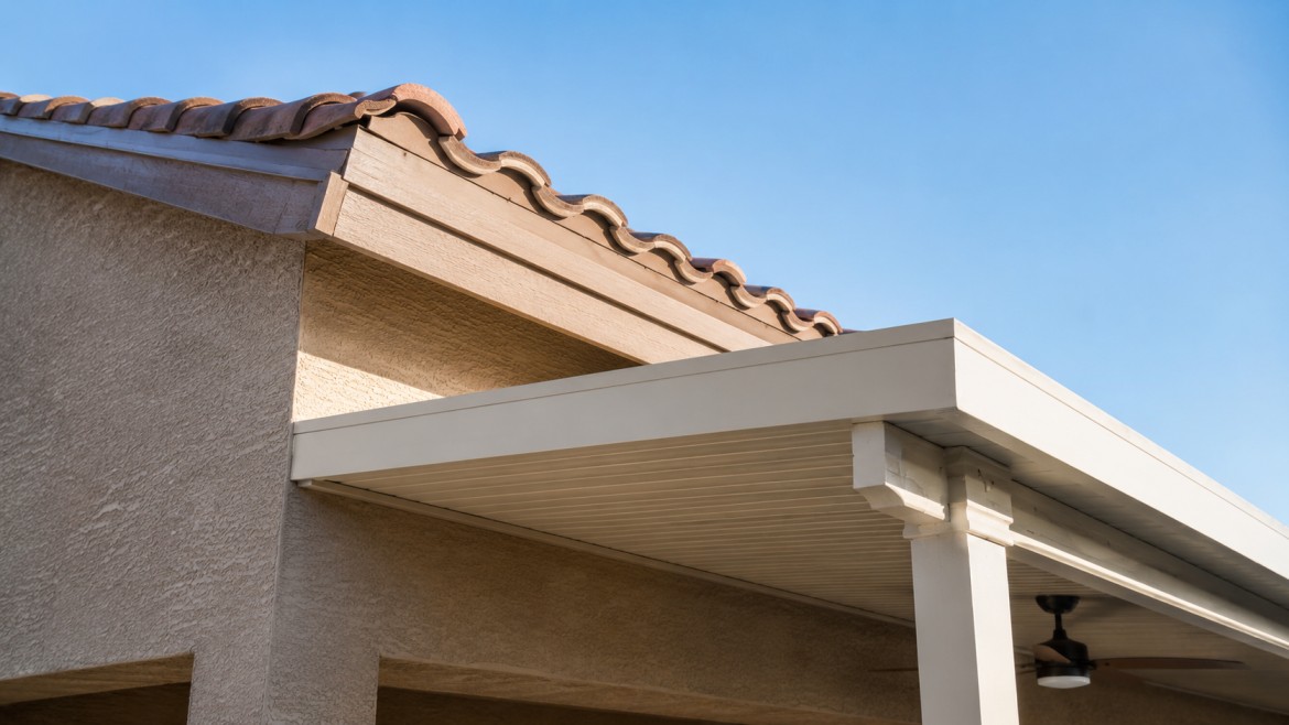 Attachment point where an aluminum patio cover ties into a home fascia and roofline