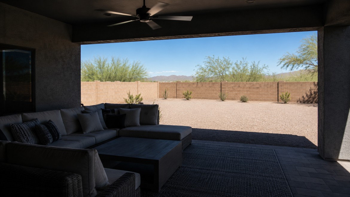 Shaded outdoor living room with ceiling fan and sectional seating during an Arizona summer