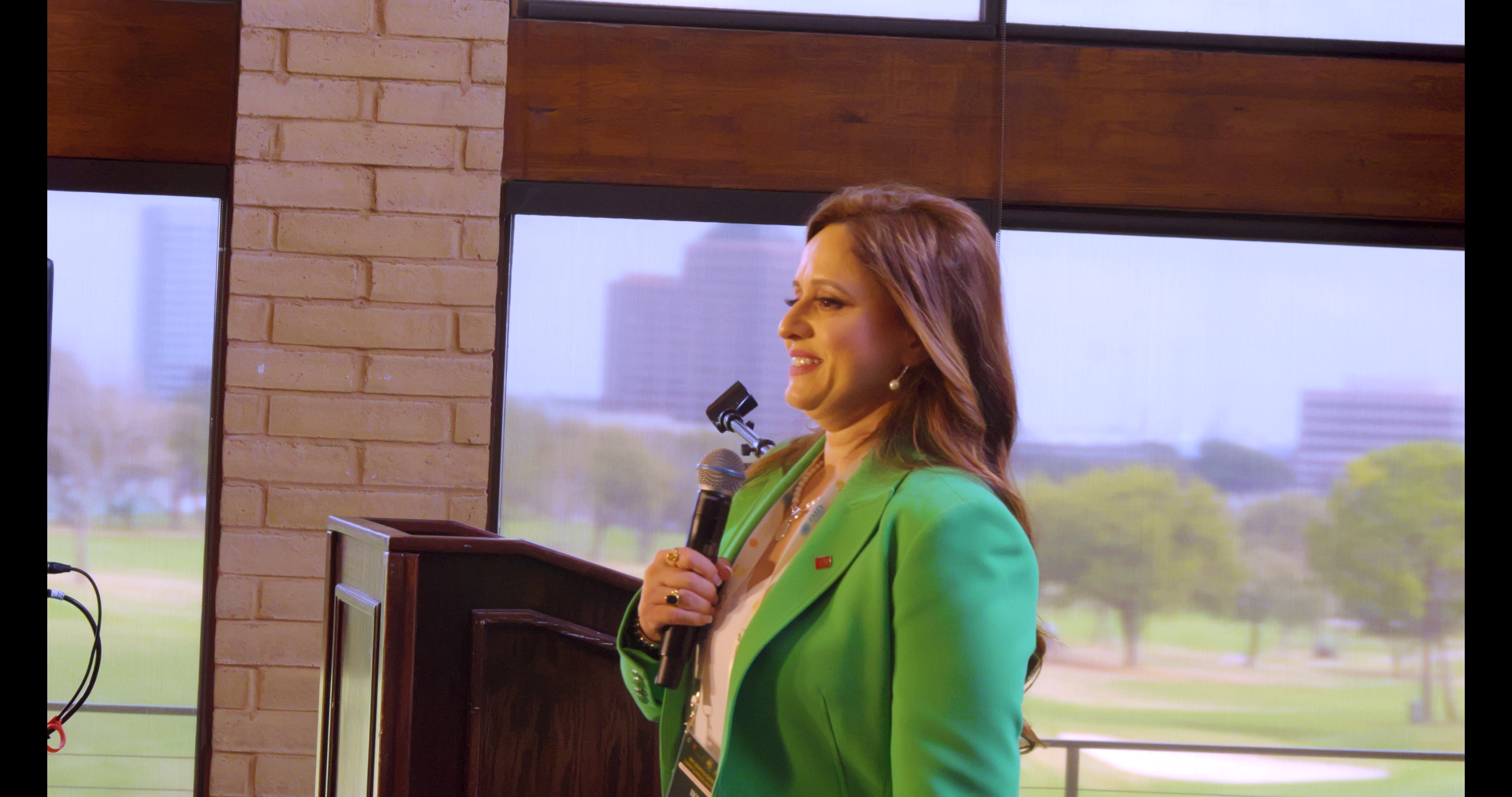 Dr. Meetu Bhatnagar speaking on stage to an audience