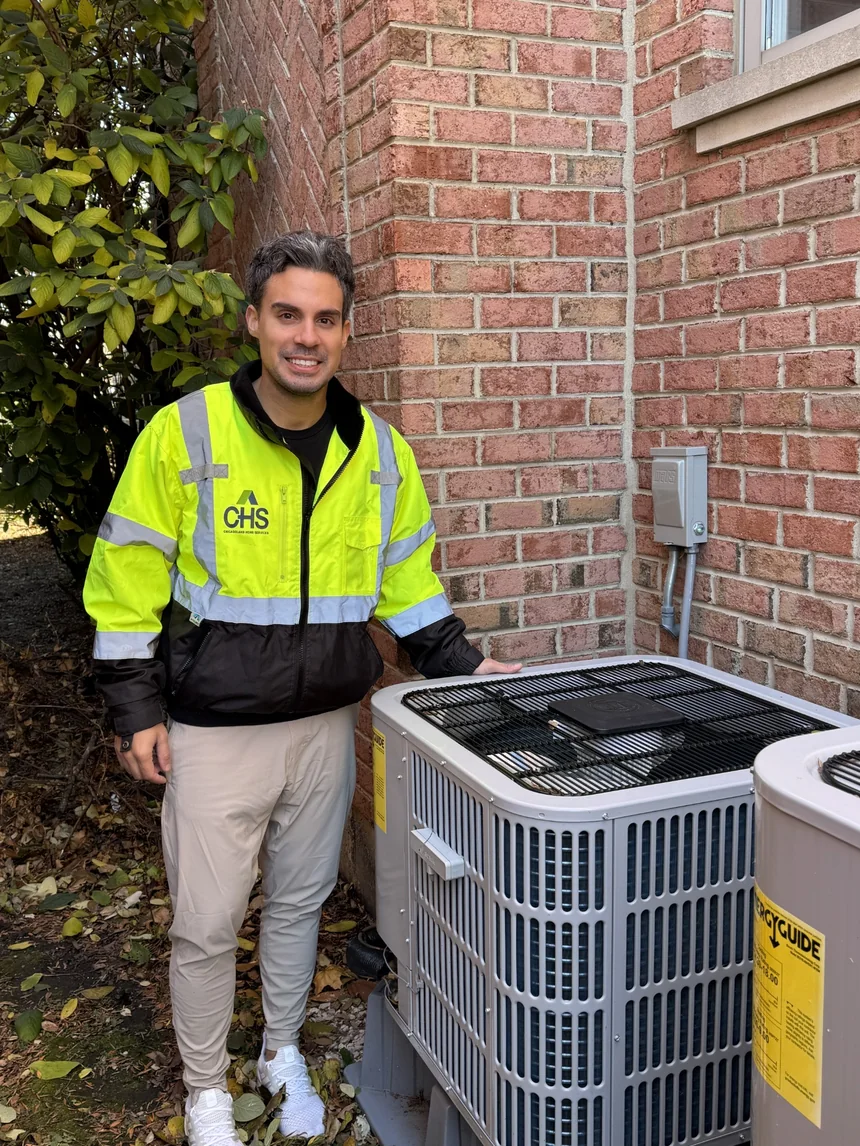 Chicagoland Home Services team member standing next to an HVAC unit