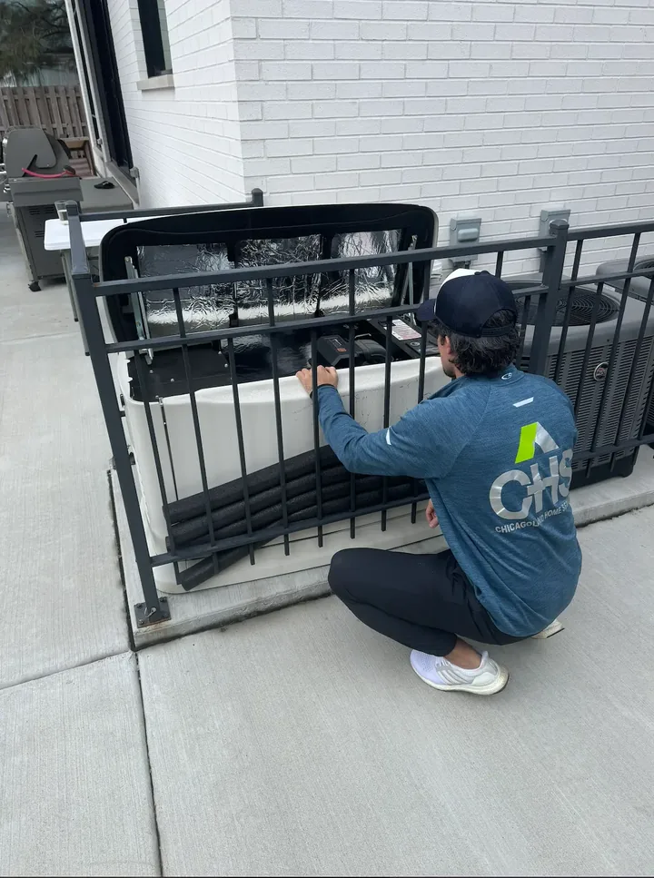 Chicagoland Home Services team member working on HVAC equipment