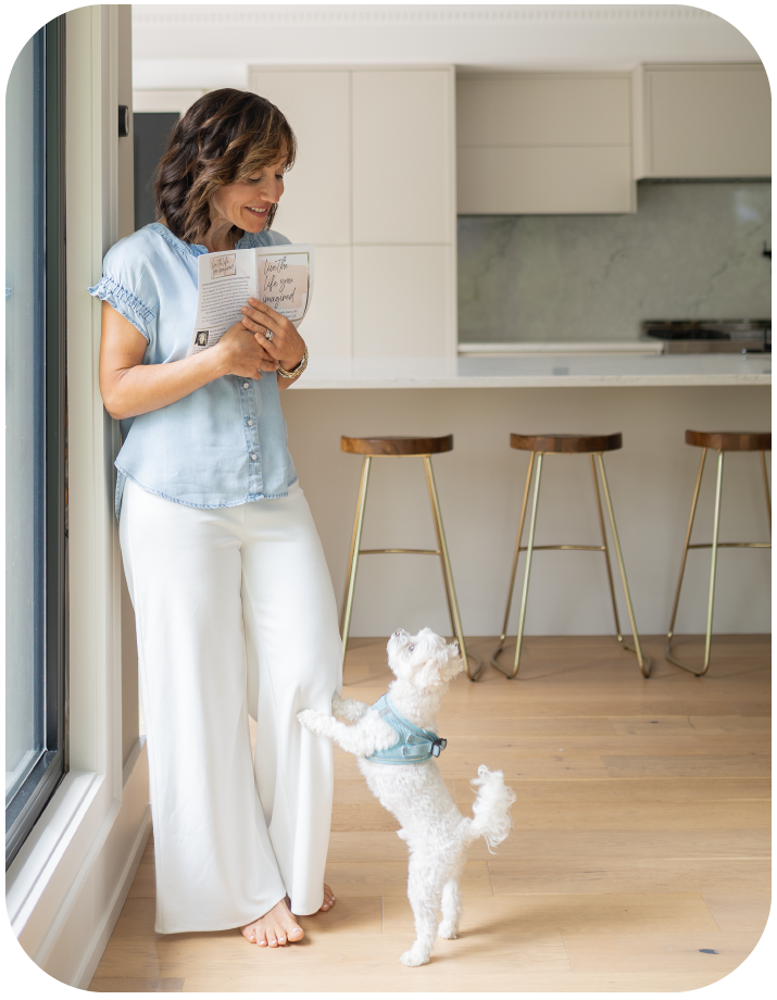 woman standing in front of fruits holding pot's lid