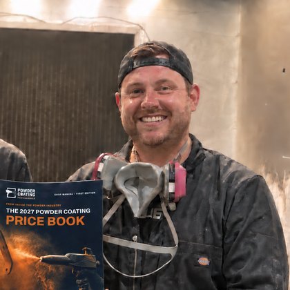 The owner of a three-person East Texas powder coating shop holding the Price Book in the blast booth