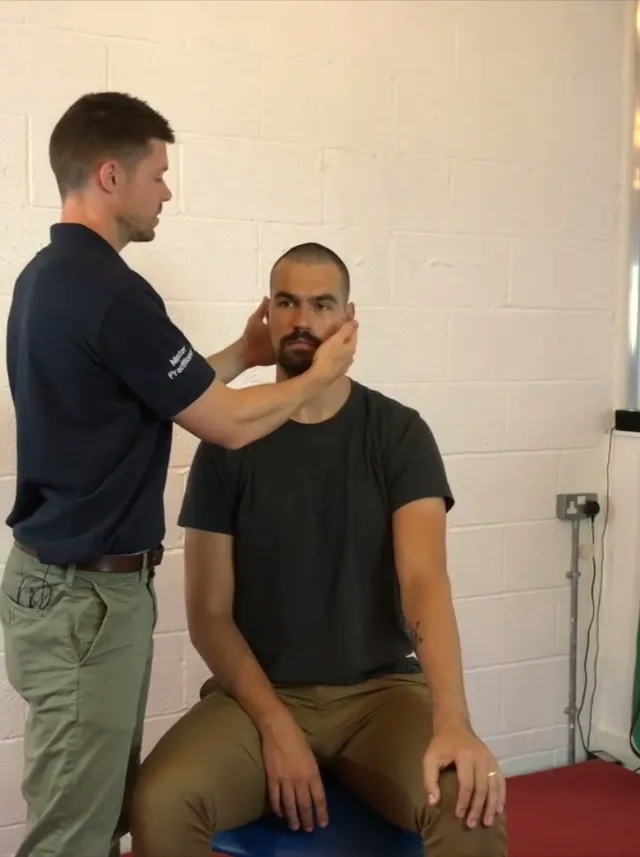 Holding the client's jaw during the TMJ screen