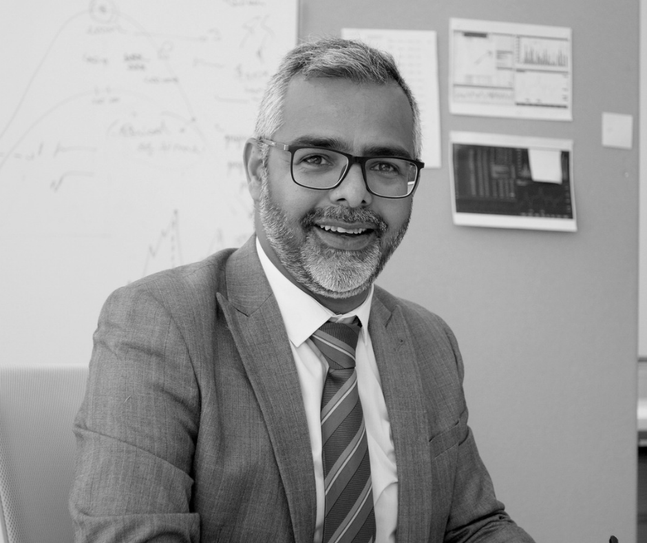 Man in suit wearing glasses smiling