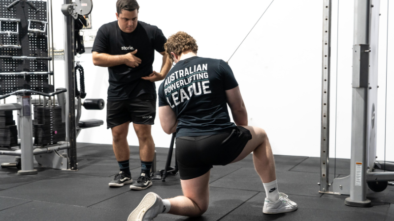 Coach watching a lift at Storiestrong HQ
