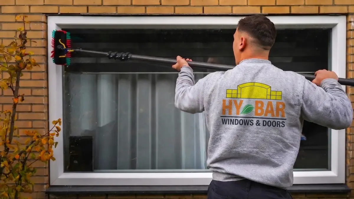 A Hybar Windows & Doors technician cleaning a window