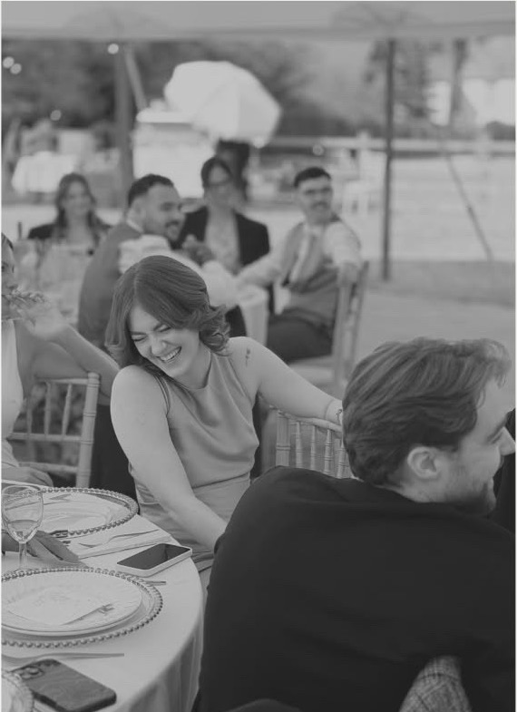 Guests laughing at a wedding breakfast table