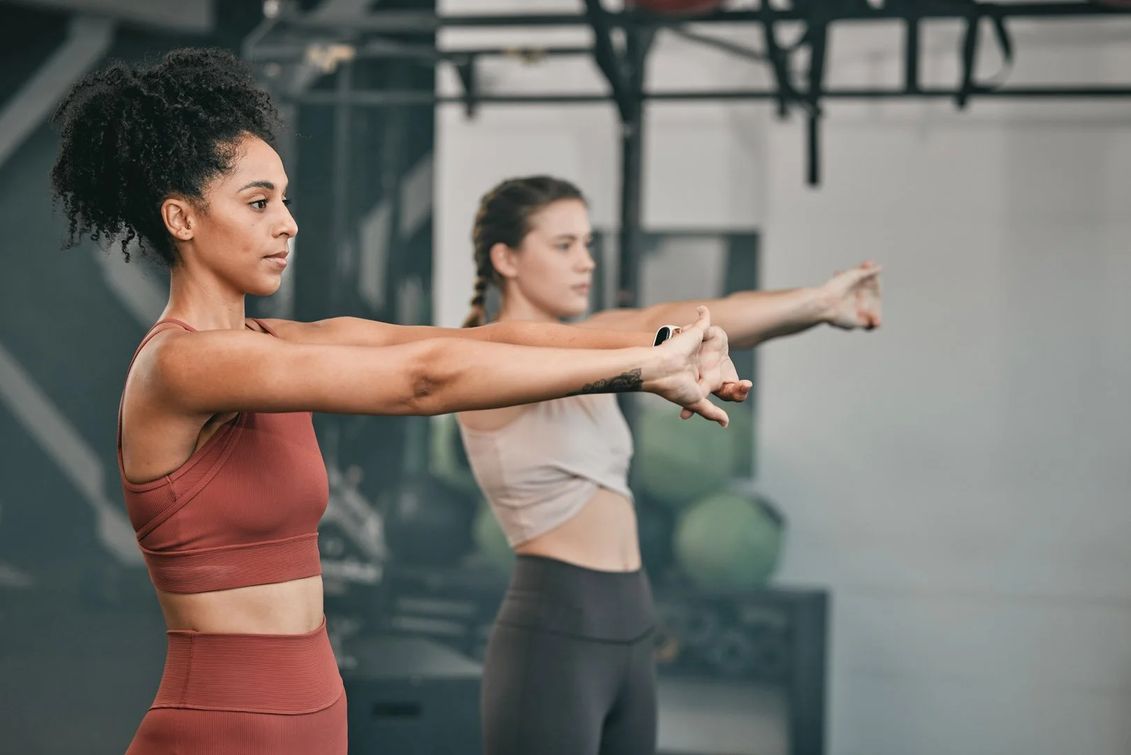 Women stretching during a group workout at GoGirl Fitness Studio