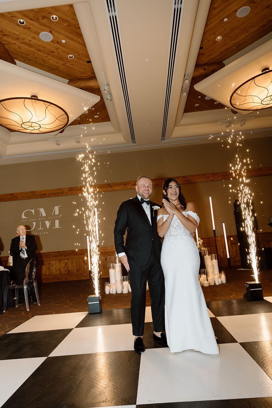 Cold sparks framing a first dance on a checkered floor