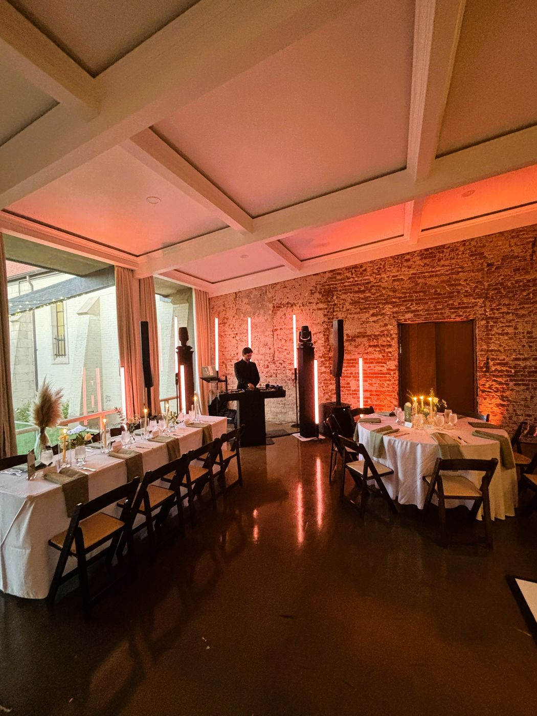 A reception room washed in warm uplighting