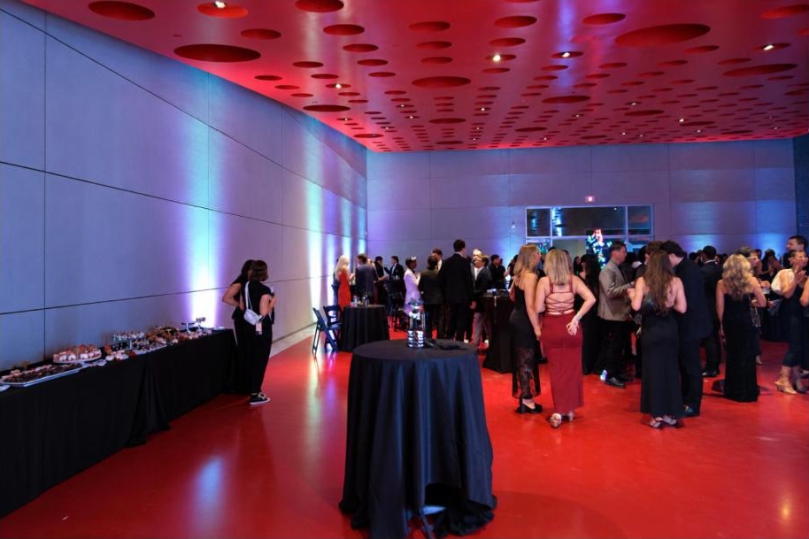 A packed corporate party at Hangar One with the crowd on the dance floor.
