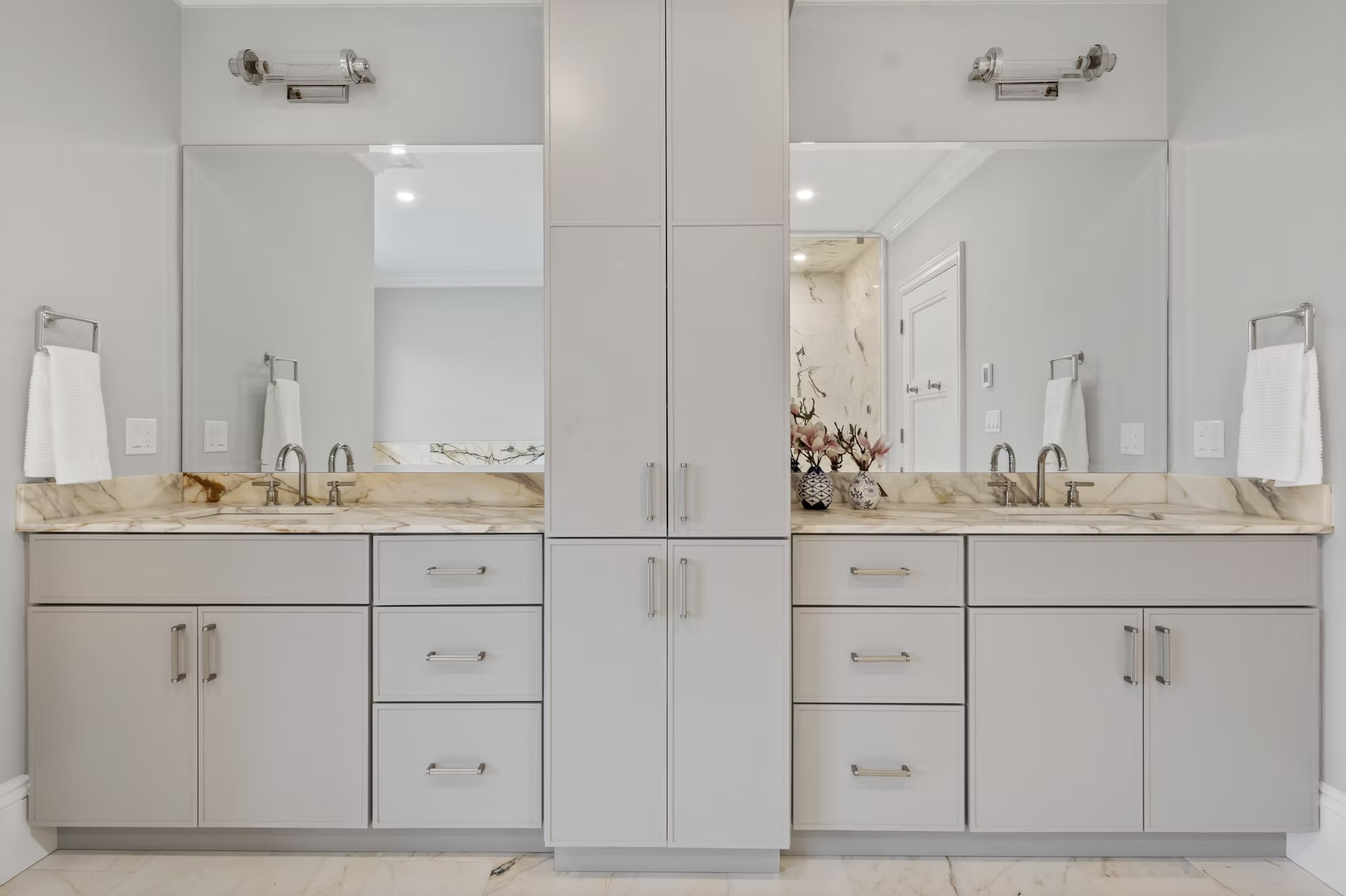 A finished custom bathroom remodel inside a Roaring Fork Valley mountain home, showing a tiled walk-in shower, wood-finish vanity, and natural stone flooring. The space reflects the clean, low-maintenance design common in Roaring Fork Valley residential builds.