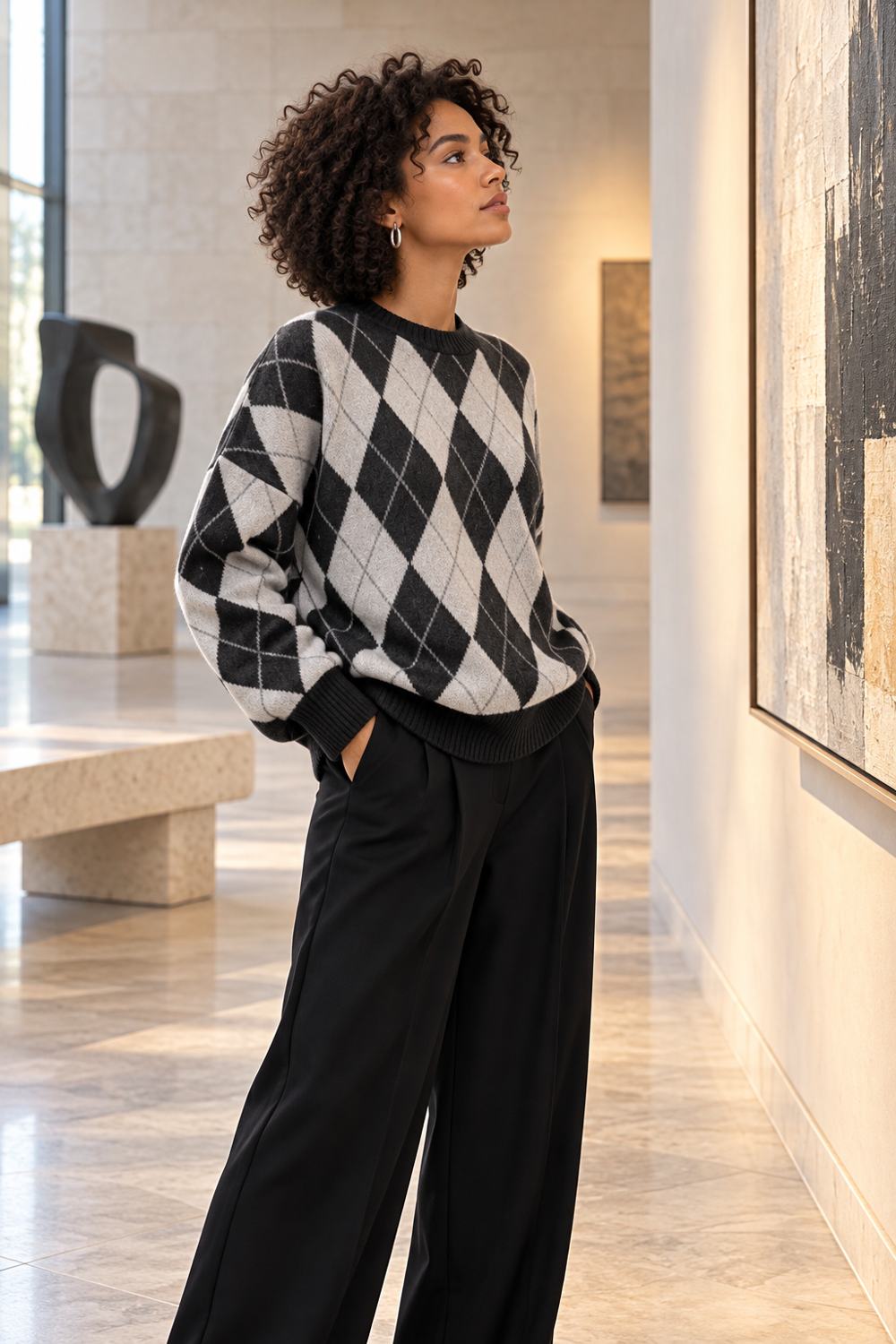 Black argyle cardigan styled with crisp contrasting basics