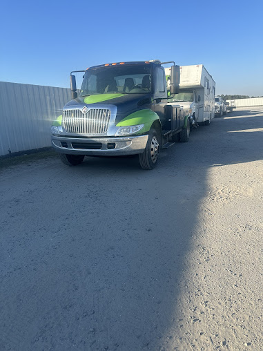 Moffo's Towing team member inspecting a vehicle before towing