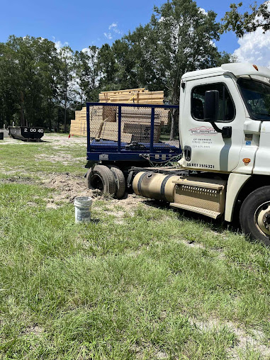 Moffo's Towing crew loading a vehicle onto a rollback bed