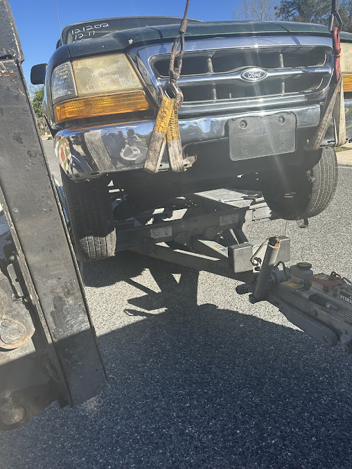 Close-up of a Moffo's Towing truck winch cable during a recovery