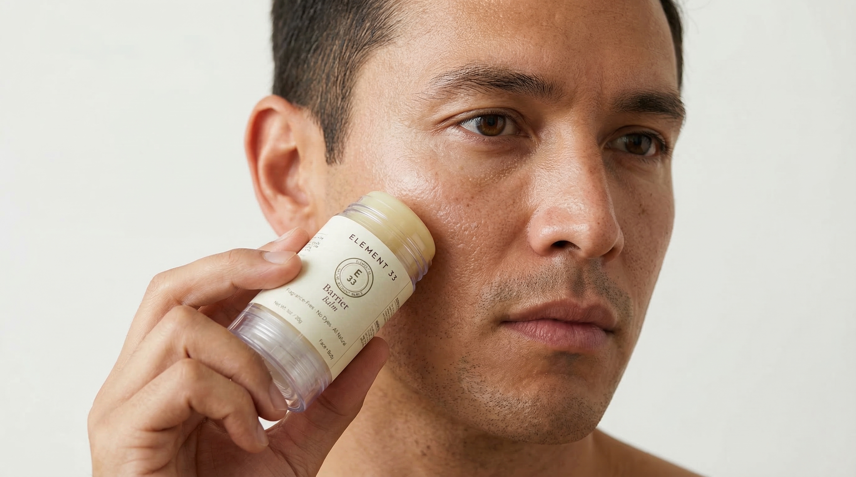 Man applying Element 33 Barrier Balm to face