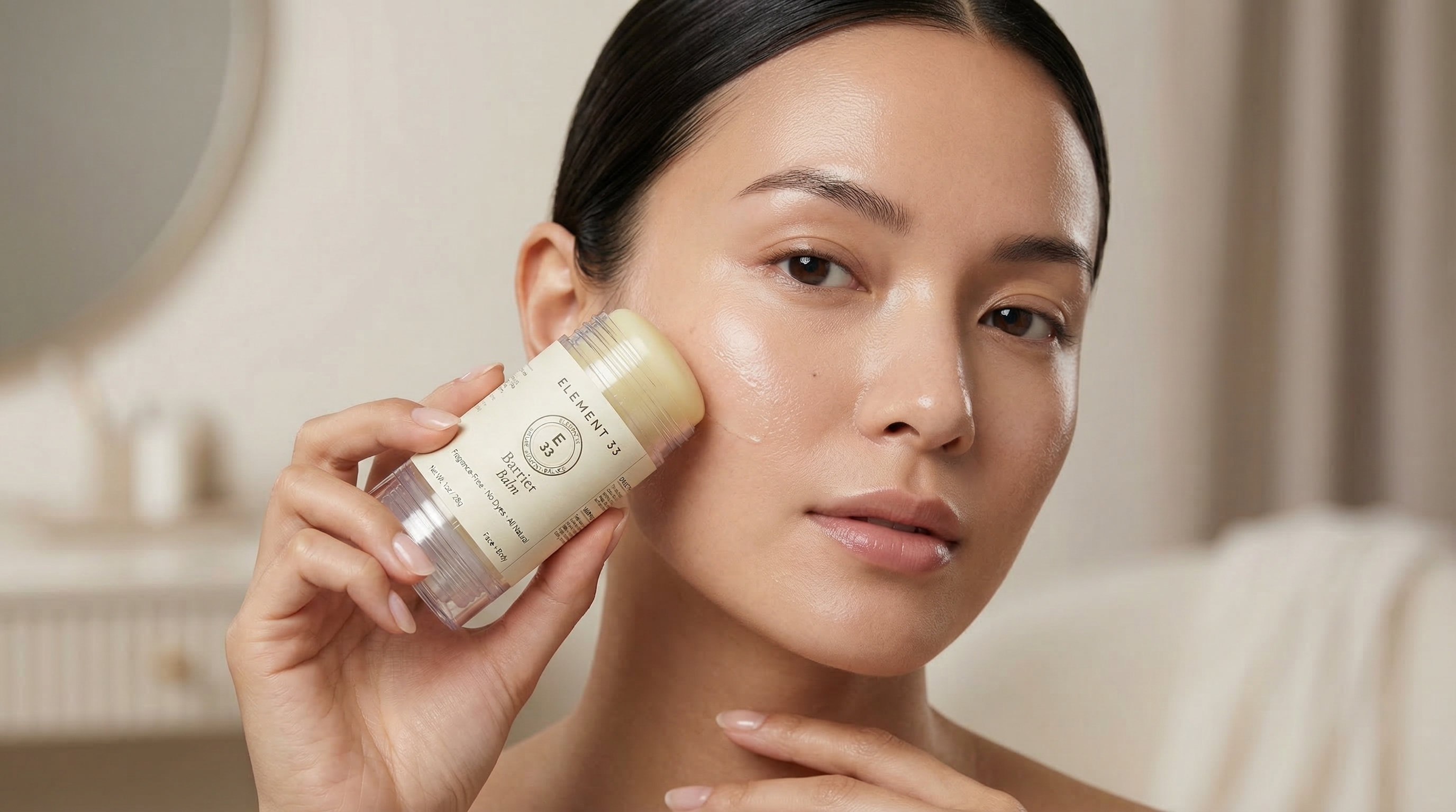 Woman applying Element 33 Barrier Balm to face