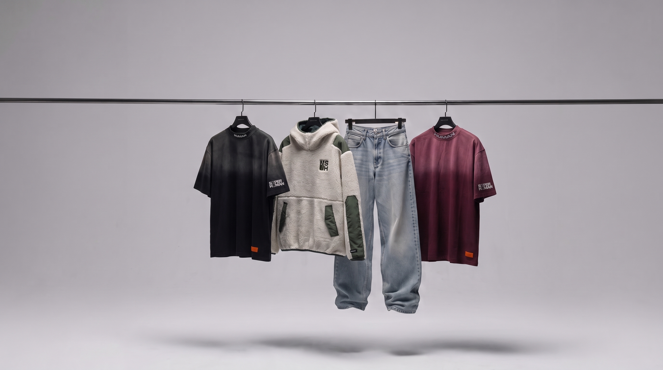 Super Human first drop — hoodie, signature tees and essentials on a rack
