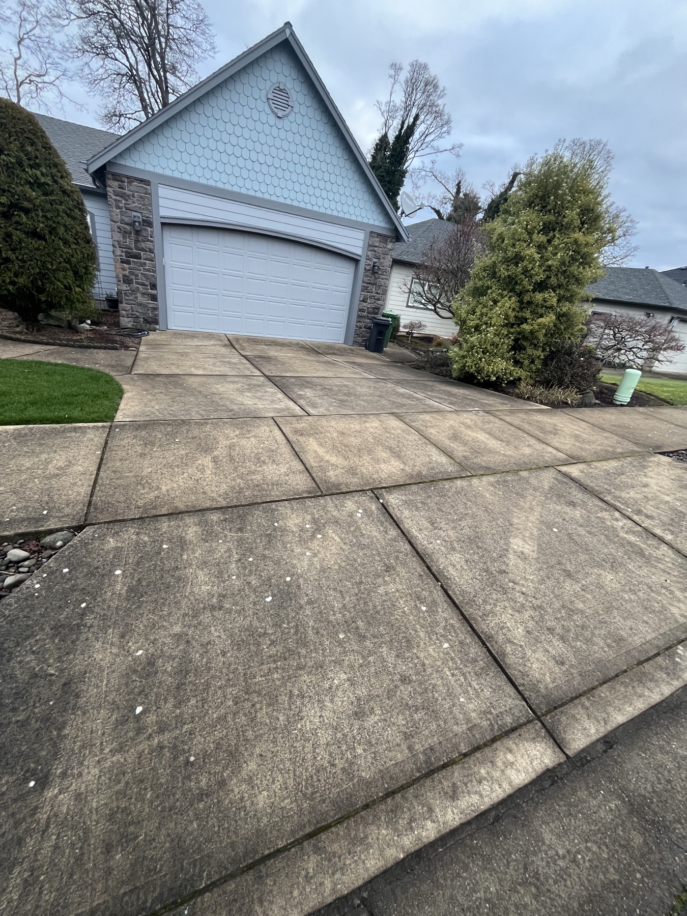 Before: Dirty concrete driveway before pressure washing