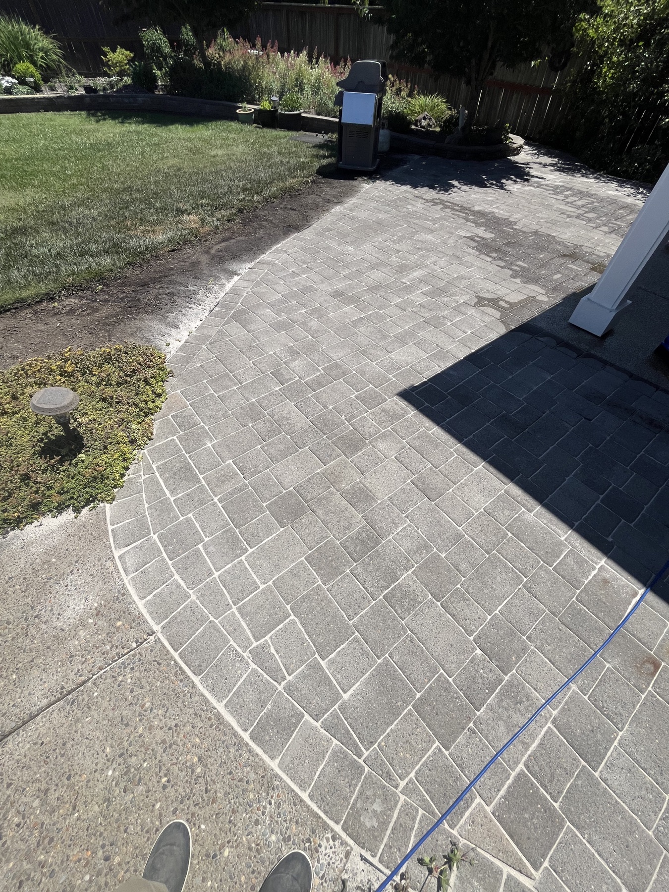 After: Mossy paver patio before pressure washing
