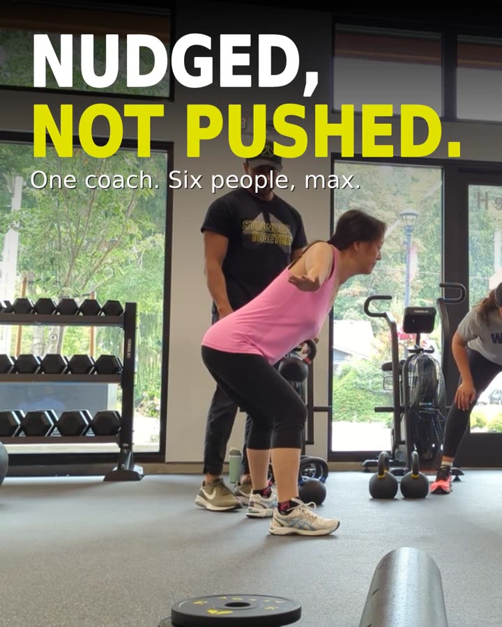 A coach correcting a member's form at Alloy Woodinville