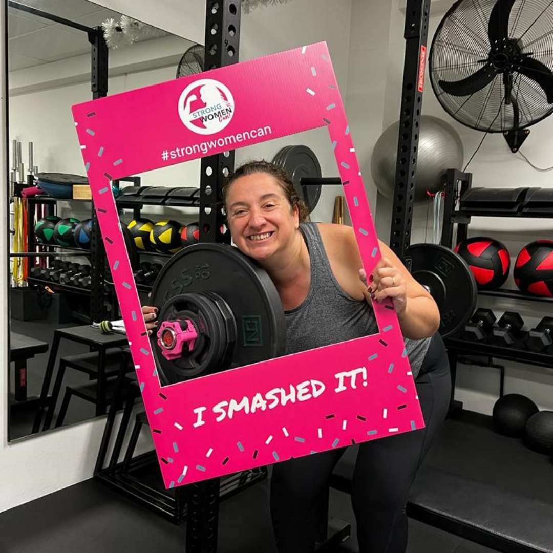 Member celebrating a lift with an I Smashed It frame